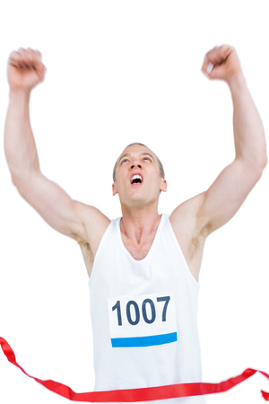 Young athlete winning race on white backgroundの写真素材