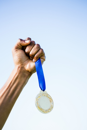 Determined relay athlete running with baton running trackの写真素材