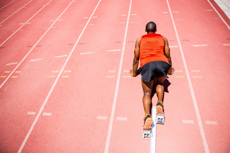 Determined athlete ready to run on running track
