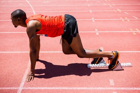 Determined athlete ready to run on running track