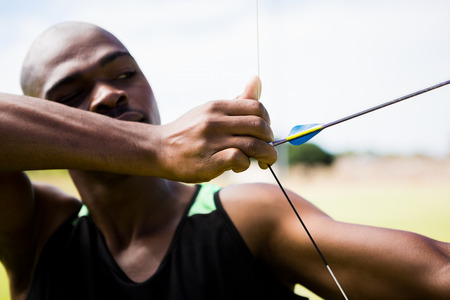 Athlete practicing archery in stadium