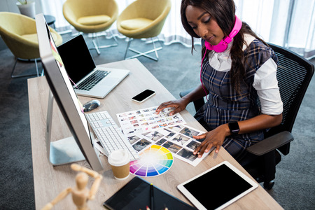 Business woman looking at pictures in the office