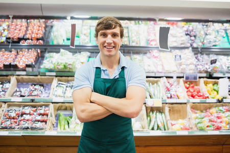 Portrait of man grocer smiling with his arms crossedの写真素材