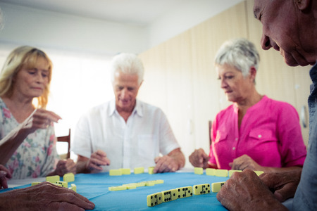 Group of seniors playing dominoes in the retirement houseの写真素材