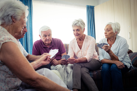 Group of seniors playing cards in the retirement houseの写真素材