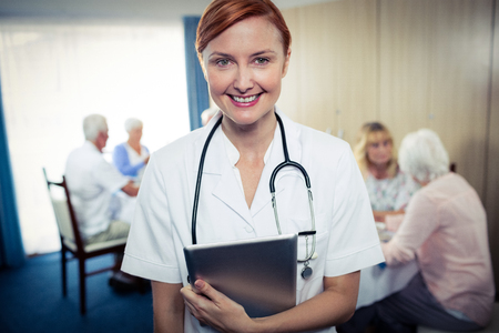 Portrait of a nurse with tablet computer in the retirement house