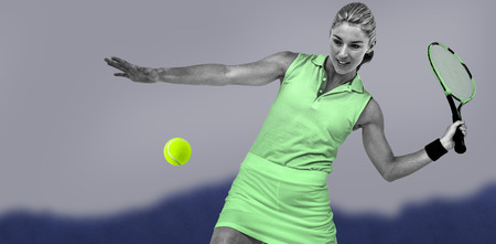 Athlete playing tennis with a racket  against blurred mountainsの写真素材