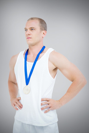 Close-up of athlete with  medal against grey backgroundの写真素材