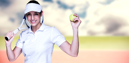 Female athlete playing tennis against composite image of tennis fieldの写真素材