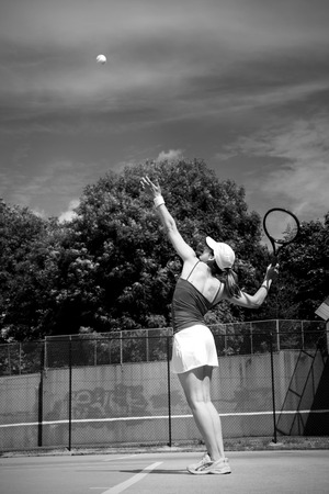 Tennis player about to serve on a sunny dayの写真素材