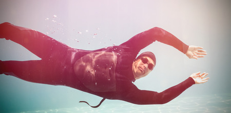 Portrait of young man swimming underwaterの写真素材