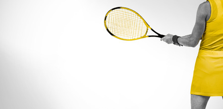 Athlete playing tennis with a racket  against white background with vignetteの写真素材