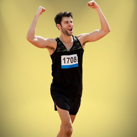 Sportsman celebrating his victory against yellow background