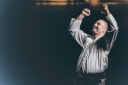 Fighter posing after victory against black backgroundの写真素材