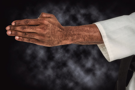 Close up view oh hands against dark backgroundの写真素材