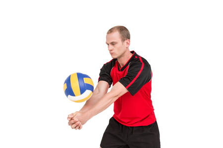 Sportsman playing a volleyball on white backgroundの写真素材