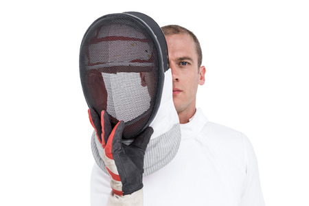 Portrait of swordsman holding fencing mask on white backgroundの写真素材