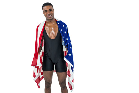 Athlete posing with american flag wrapped around his body on white backgroundの写真素材