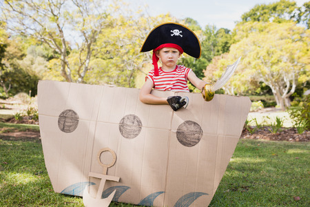 Facing view of boy dressing up as pirate in a parkの写真素材