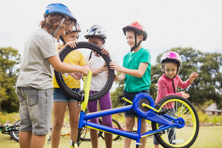 Children playing with bike in the park in the parkの写真素材