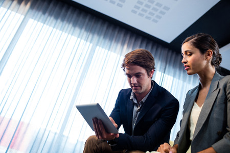 Businessmen using a tablet in officeの写真素材