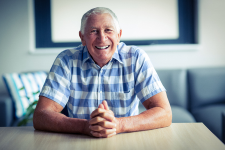 Portrait of senior man smiling at homeの写真素材