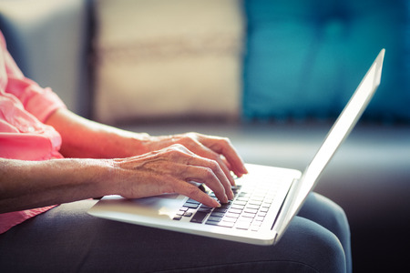 Senior woman using laptop at home