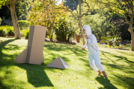Boy pretending to be an astronaut in parkの写真素材
