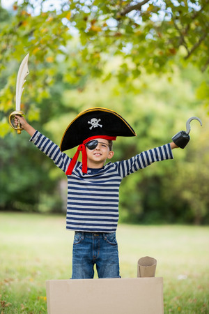 Boy pretending to be a pirate in the parkの写真素材