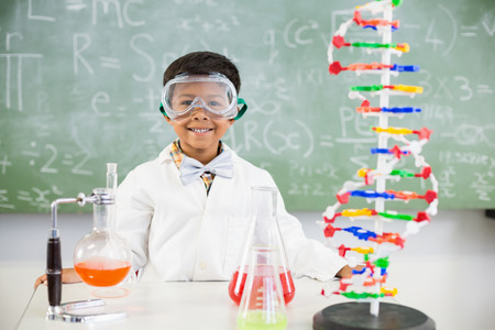 Portrait of schoolboy doing a chemical experiment in laboratory at school