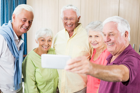 Seniors taking a selfie in a retirement homeの写真素材