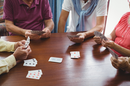 Seniors playing cards in a retirement home