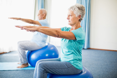 Seniors using exercise ball in a studioの写真素材