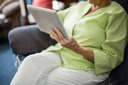 Senior woman using a tablet in a retirement homeの写真素材
