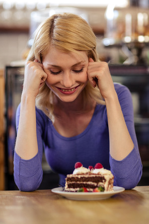 Customer with a cake alone in the restaurantの写真素材