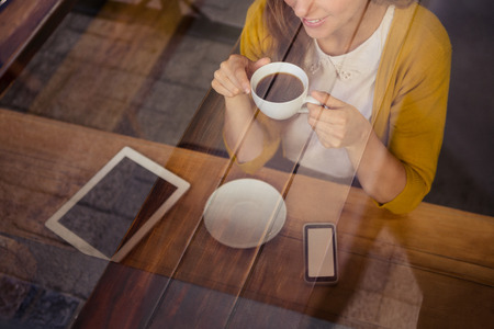 Casual woman drinking a coffee in a restaurantの写真素材