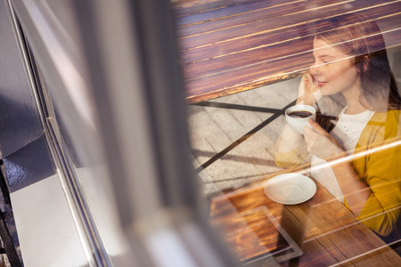 Casual woman on the phone in a restaurant