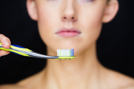 Focus on thoothbrush with a smile in a studioの写真素材