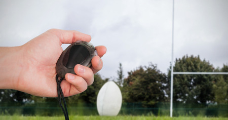 Close up of a hand holding a chronometer in a rugby pitchの写真素材