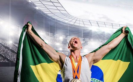 Athlete posing with gold medals after victory against sports arenaの写真素材