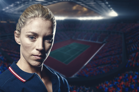 Portrait of female tennis player against tennis field on a stadiumの写真素材