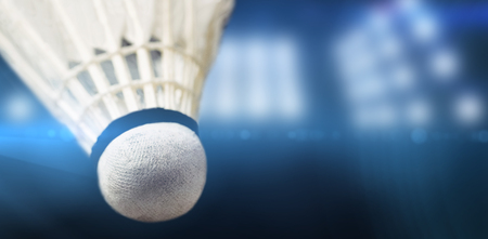 Close up of shuttlecock against composite image of spotlightの写真素材