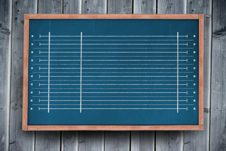 Coloured lines on a white background against blackboard with copy space on wooden boardの写真素材