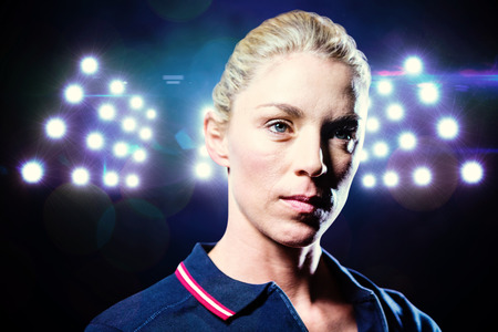 Close-up of female tennis player against composite image of spotlightの写真素材