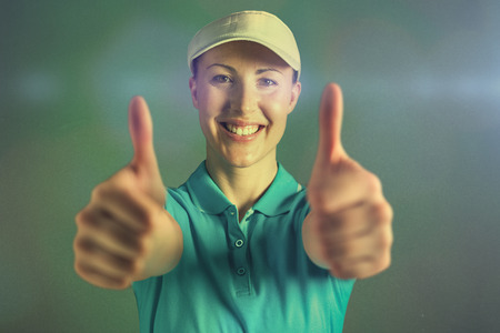 Sportswoman posing on black background against blue backgroundの写真素材