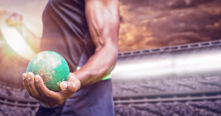 Focus on man holding hammer against composite image of stadiumの写真素材