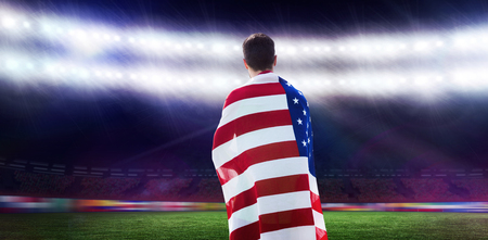 Rear view of american sportsman is posing  against rugby stadiumの写真素材