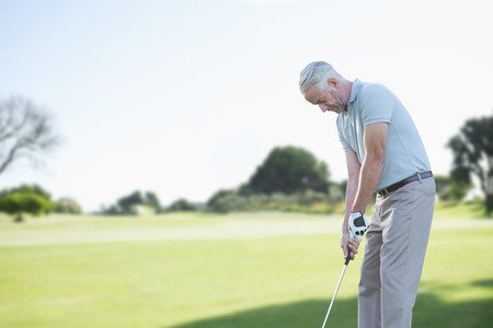 Man doing golf against view of a parkの写真素材