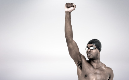 Swimmer posing after victory against grey backgroundの写真素材