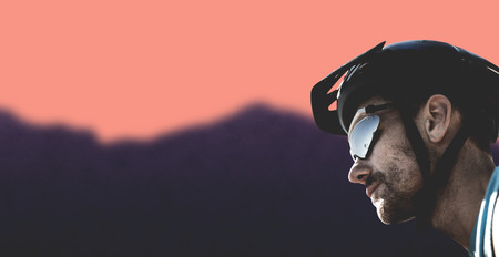 Man wearing a helmet against blurred mountainsの写真素材